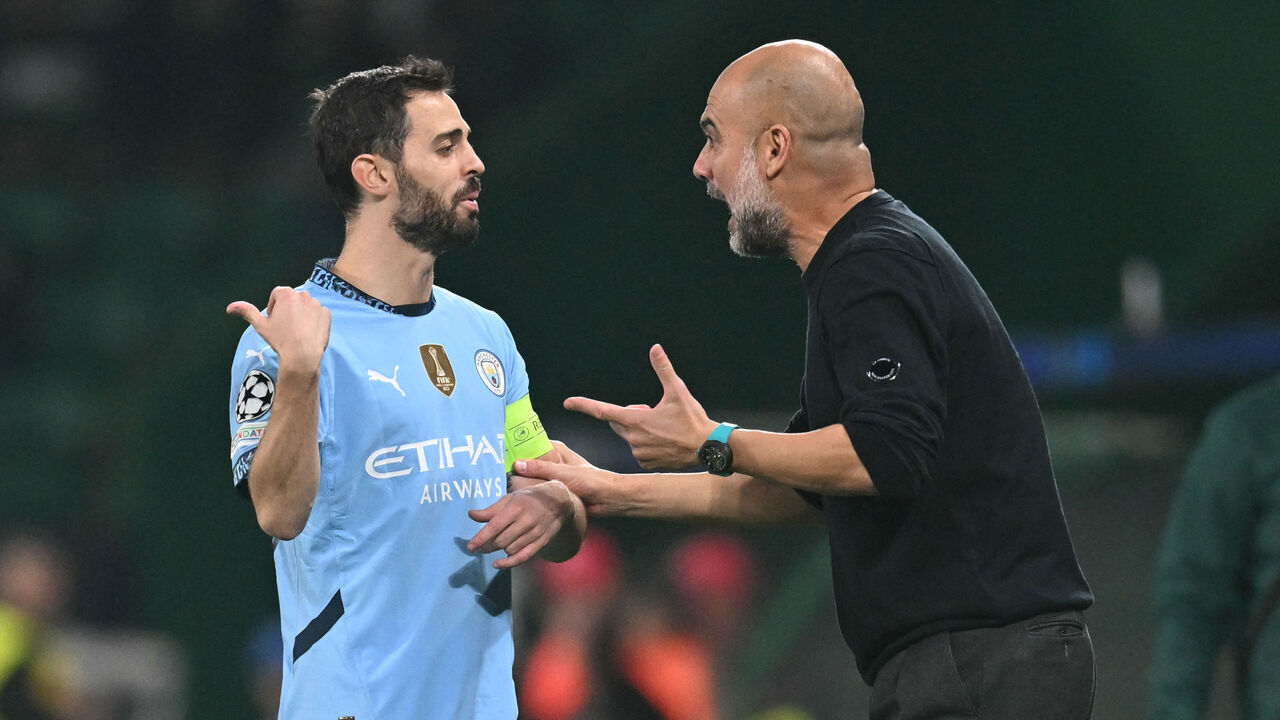 Manchester City's Spanish manager Pep Guardiola talks with Manchester City's Portuguese midfielder #20 Bernardo Silva during the UEFA Champions League, league phase day 4 football match between Sporting Lisbon and Manchester City at the Jose Alvalade stadium in Lisbon on November 5, 2024.
