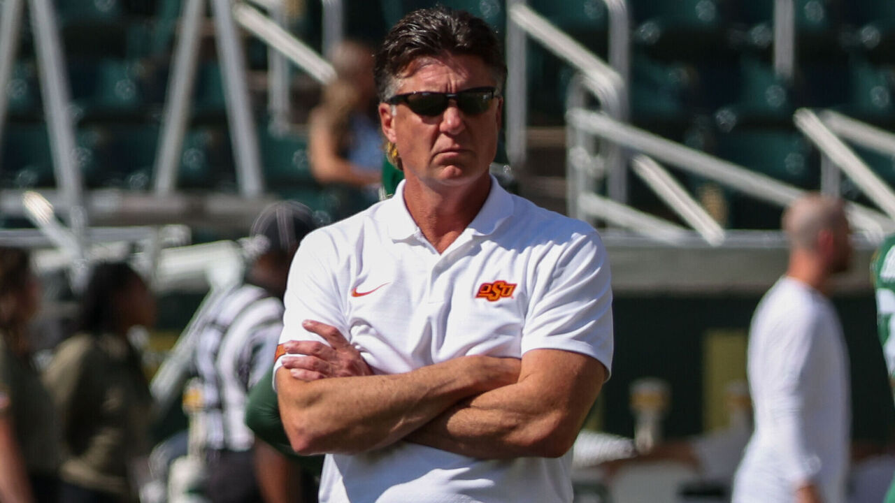 WACO, TX - OCTOBER 26: Oklahoma State Cowboys head coach Mike Gundy watches his team warm up before the Big 12 college football game between Baylor Bears and Oklahoma State Cowboys on October 26, 2024, at McLane Stadium in Waco, TX.