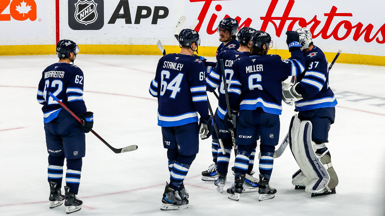 WINNIPEG, CANADA - NOVEMBER 5: Winnipeg Jets players congratulate goaltender Connor Hellebuyck #37 following a 3-0 shutout victory over the Utah Hockey Club at the Canada Life Centre on November 5, 2024 in Winnipeg, Manitoba, Canada.