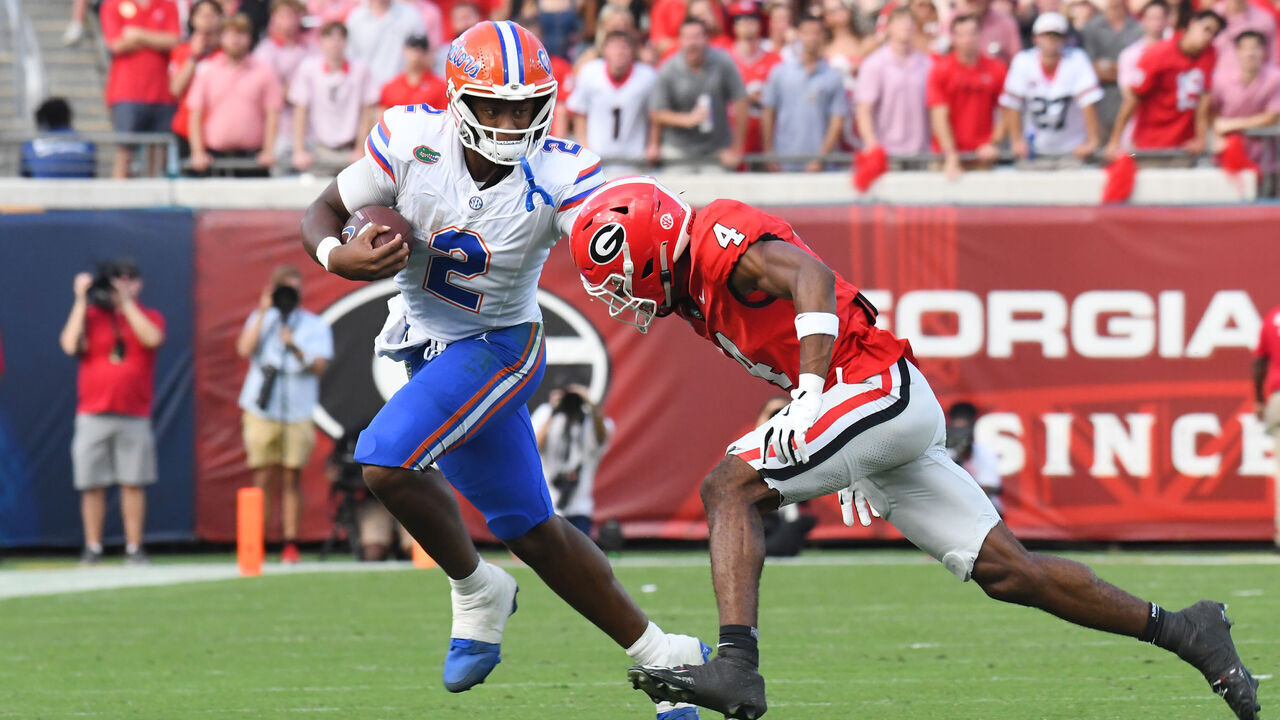JACKSONVILLE, FL - NOVEMBER 2: DJ Lagway #2 of the Florida Gators runs the ball past KJ Bolden #4 of the Georgia Bulldogs during a game between University of Florida and University of Georgia at EverBank Stadium on November 2, 2024 in Jacksonville, Florida.