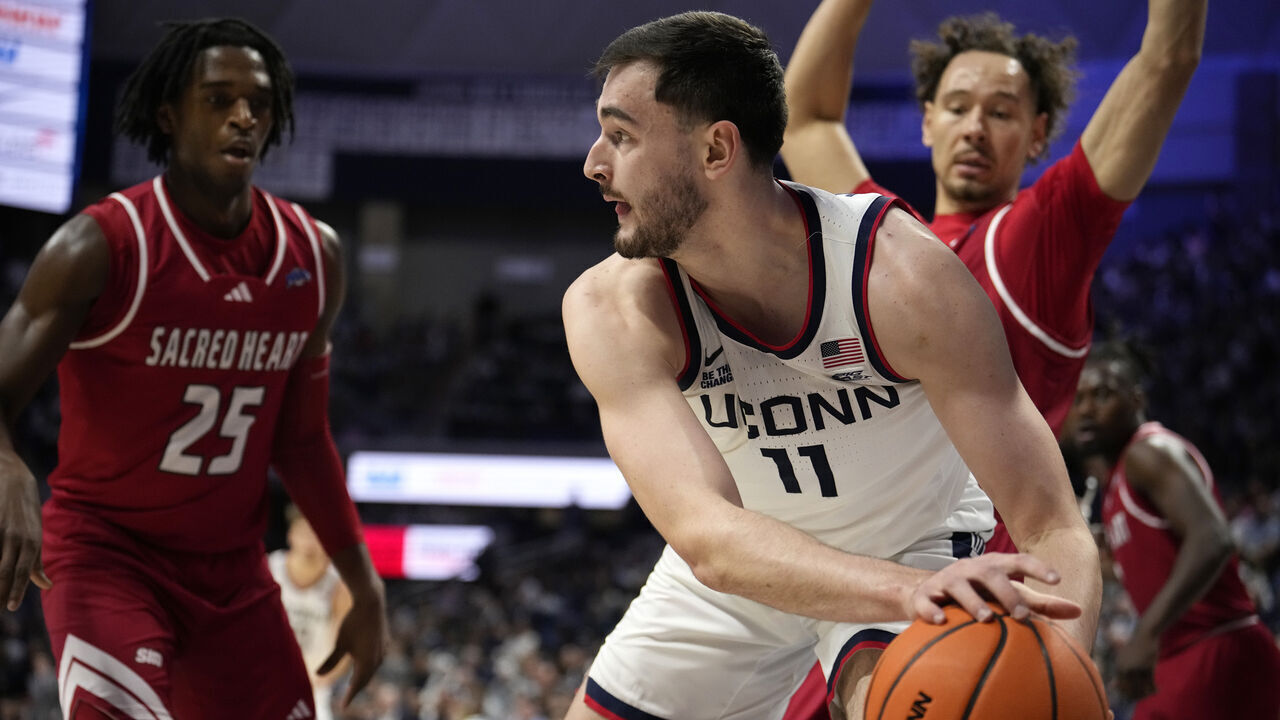 STORRS, CONNECTICUT - NOVEMBER 6: Alex Karaban #11 of the Connecticut Huskies grabs the loose ball against the Sacred Heart Pioneers during the first half of an NCAA basketball game at the Harry A. Gampel Pavilion on November 6, 2024 in Storrs, Connecticut.