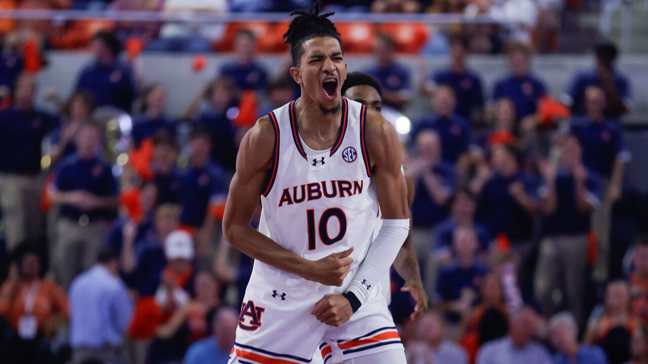 AUBURN, ALABAMA - NOVEMBER 6: Chad Baker-Mazara #10 of the Auburn Tigers celebrates a slam dunk by a teammate during the first half against the Vermont Catamounts at Neville Arena on November 6, 2024 in Auburn, Alabama.
