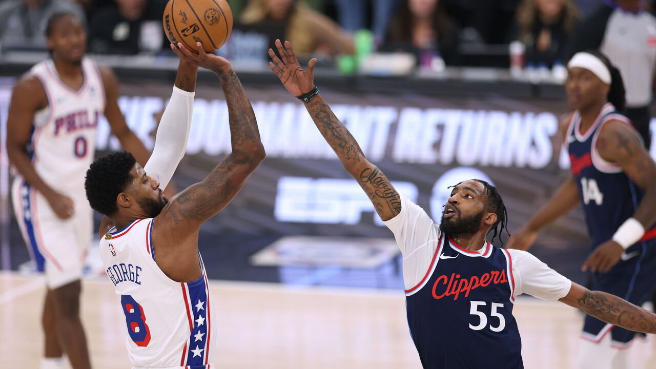 INGLEWOOD, CALIFORNIA - NOVEMBER 06: Paul George #8 of the Philadelphia 76ers scores on a three point attempt over Derrick Jones Jr. #55 of the LA Clippers during the first quarter at Intuit Dome on November 06, 2024 in Inglewood, California.