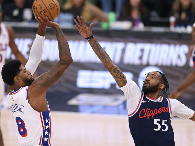 INGLEWOOD, CALIFORNIA - NOVEMBER 06: Paul George #8 of the Philadelphia 76ers scores on a three point attempt over Derrick Jones Jr. #55 of the LA Clippers during the first quarter at Intuit Dome on November 06, 2024 in Inglewood, California.