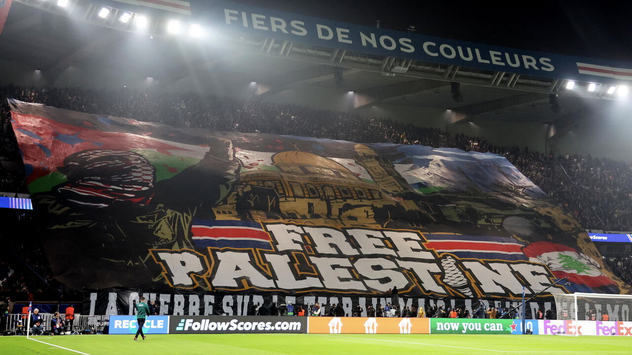 PARIS, FRANCE - NOVEMBER 06: Ultra fans of Paris Saint-Germain unroll a " Free Palestine" banner during the UEFA Champions League 2024/25 League Phase MD4 match between Paris Saint-Germain and Atletico de Madrid at Parc des Princes on November 06, 2024 in Paris, France.