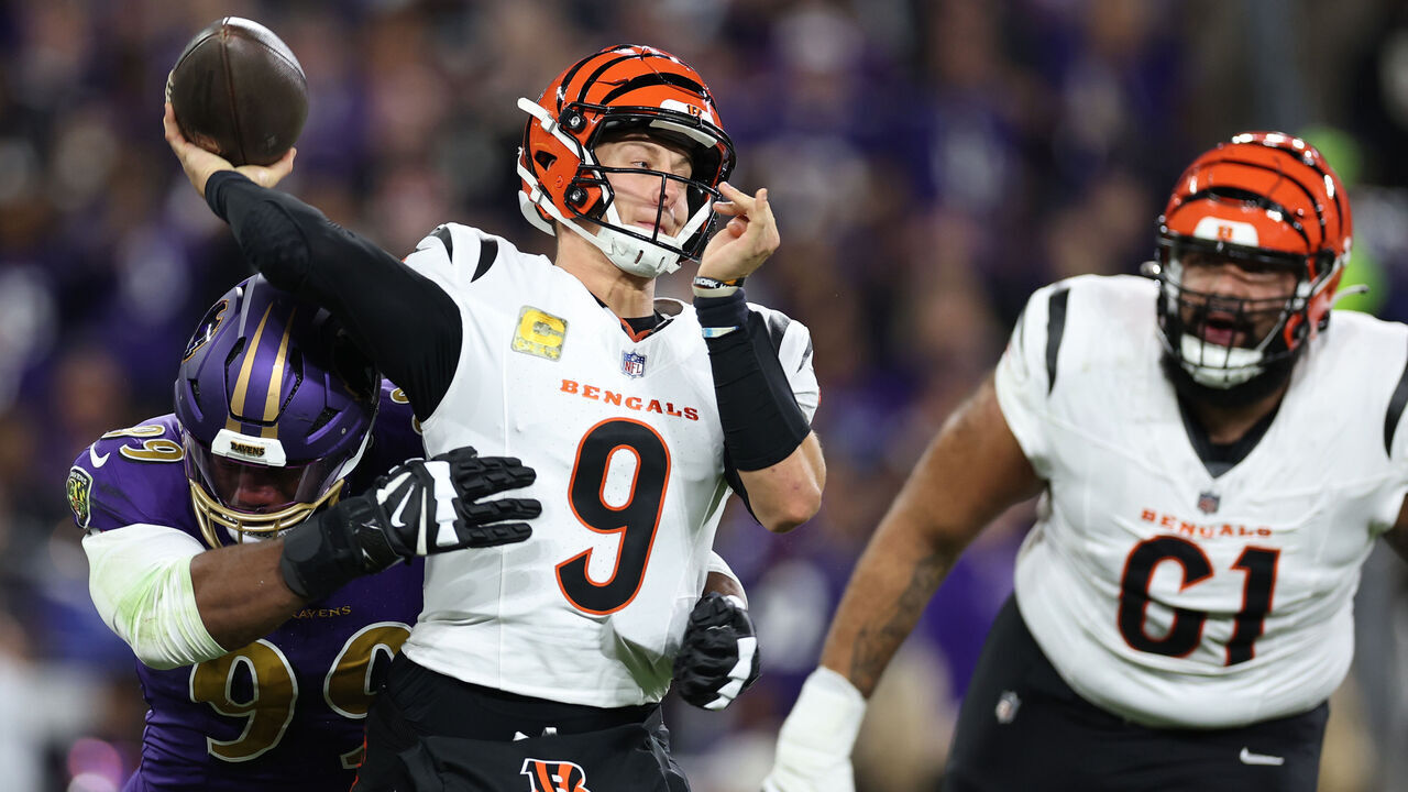 BALTIMORE, MARYLAND - NOVEMBER 07: Joe Burrow #9 of the Cincinnati Bengals is hit as he attempts a pass by Odafe Oweh #99 of the Baltimore Ravens during the first quarter at M&T Bank Stadium on November 07, 2024 in Baltimore, Maryland.