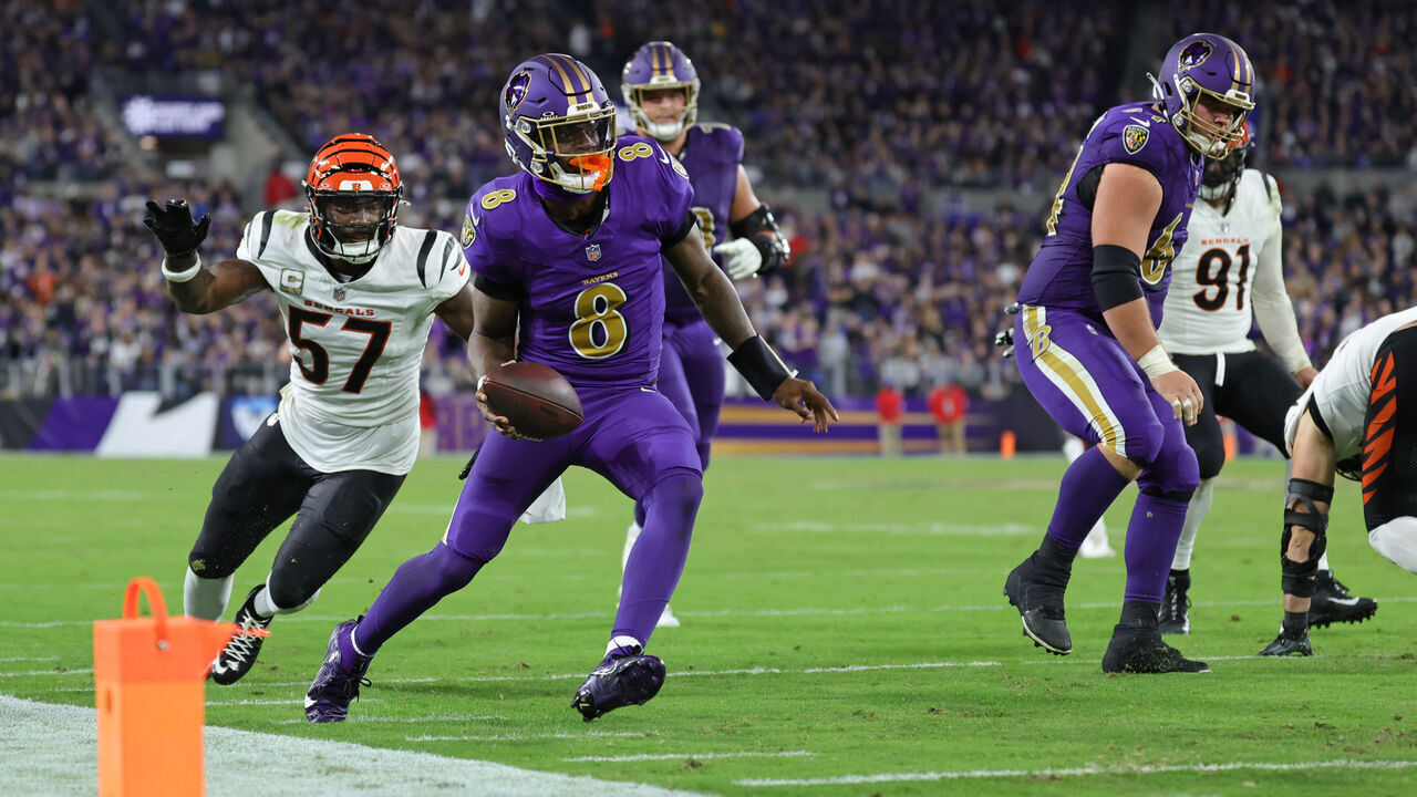 BALTIMORE, MARYLAND - NOVEMBER 07: Lamar Jackson #8 of the Baltimore Ravens carries the ball in front of Germaine Pratt #57 of the Cincinnati Bengals during the third quarter at M&T Bank Stadium on November 07, 2024 in Baltimore, Maryland.