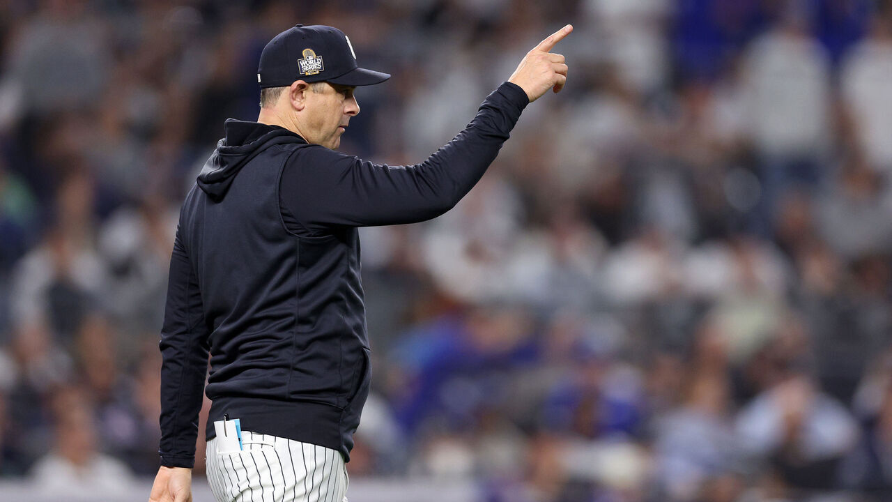 NEW YORK, NEW YORK - OCTOBER 30: Manager Aaron Boone #17 of the New York Yankees motions to the bullpen during the eighth inning of Game Five of the 2024 World Series against the Los Angeles Dodgers at Yankee Stadium on October 30, 2024 in the Bronx borough of New York City.