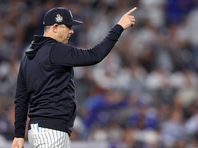NEW YORK, NEW YORK - OCTOBER 30: Manager Aaron Boone #17 of the New York Yankees motions to the bullpen during the eighth inning of Game Five of the 2024 World Series against the Los Angeles Dodgers at Yankee Stadium on October 30, 2024 in the Bronx borough of New York City.