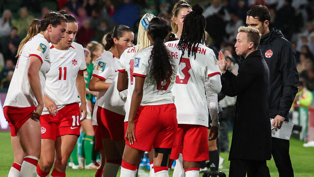 Canada's coach Beverly Priestman (R) speaks with her players on the touchline during the Australia and New Zealand 2023 Women's World Cup Group B football match between Canada and Ireland at Perth Rectangular Stadium in Perth on July 26, 2023.