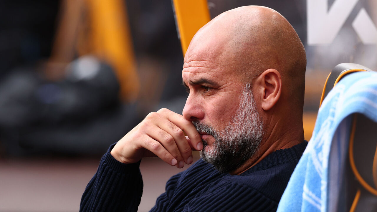 WOLVERHAMPTON, ENGLAND - OCTOBER 20: Manchester City Manager Pep Guardiola takes his seat in the dugout before kick off during the Premier League match between Wolverhampton Wanderers FC and Manchester City FC at Molineux on October 20, 2024 in Wolverhampton, England.