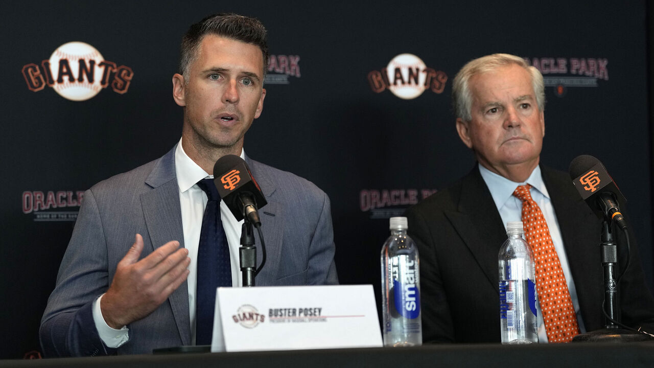 SAN FRANCISCO, CALIFORNIA - OCTOBER 1: Buster Posey and Greg Johnson speak during a press conference announcing Posey as the new President of Baseball Operations of the San Francisco Giants at Oracle Park on October 1, 2024 in San Francisco, California.