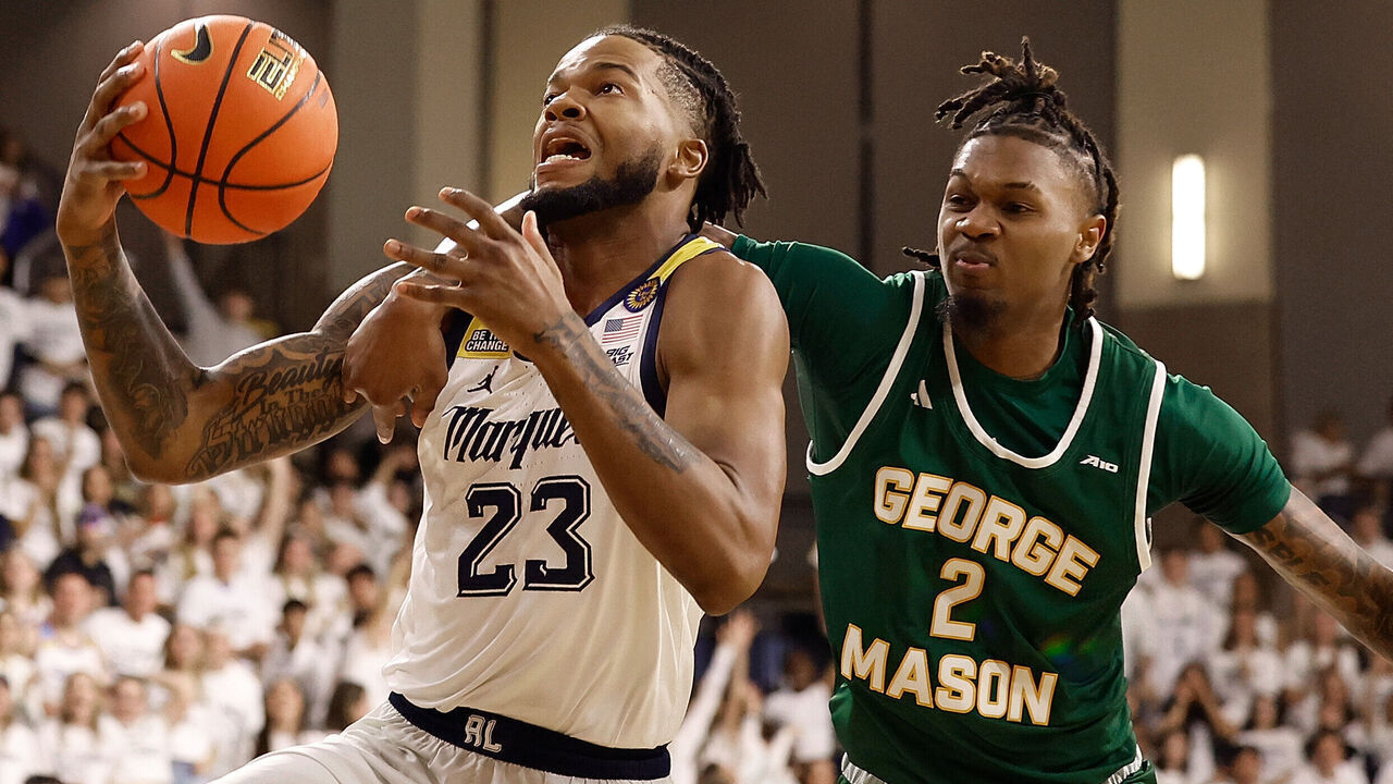MILWAUKEE, WISCONSIN - NOVEMBER 08: David Joplin #23 of the Marquette Golden Eagles is fouled while driving to the basket by Woody Newton #2 of the George Mason Patriots in the first half of the game at Al McGuire Center on November 08, 2024 in Milwaukee, Wisconsin.