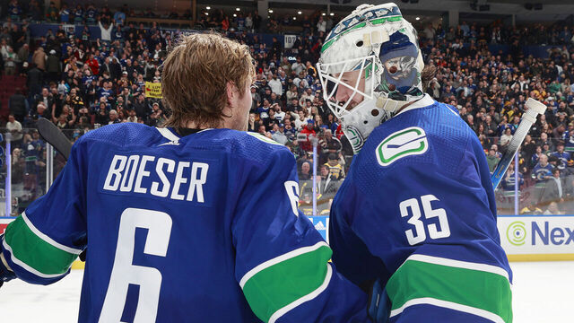 VANCOUVER, CANADA - FEBRUARY 24: Brock Boeser #6 and Thatcher Demko #35 of the Vancouver Canucks celebrate their NHL game win against the Boston Bruins at Rogers Arena on February 24, 2024 in Vancouver, British Columbia, Canada. Vancouver won 3-2.