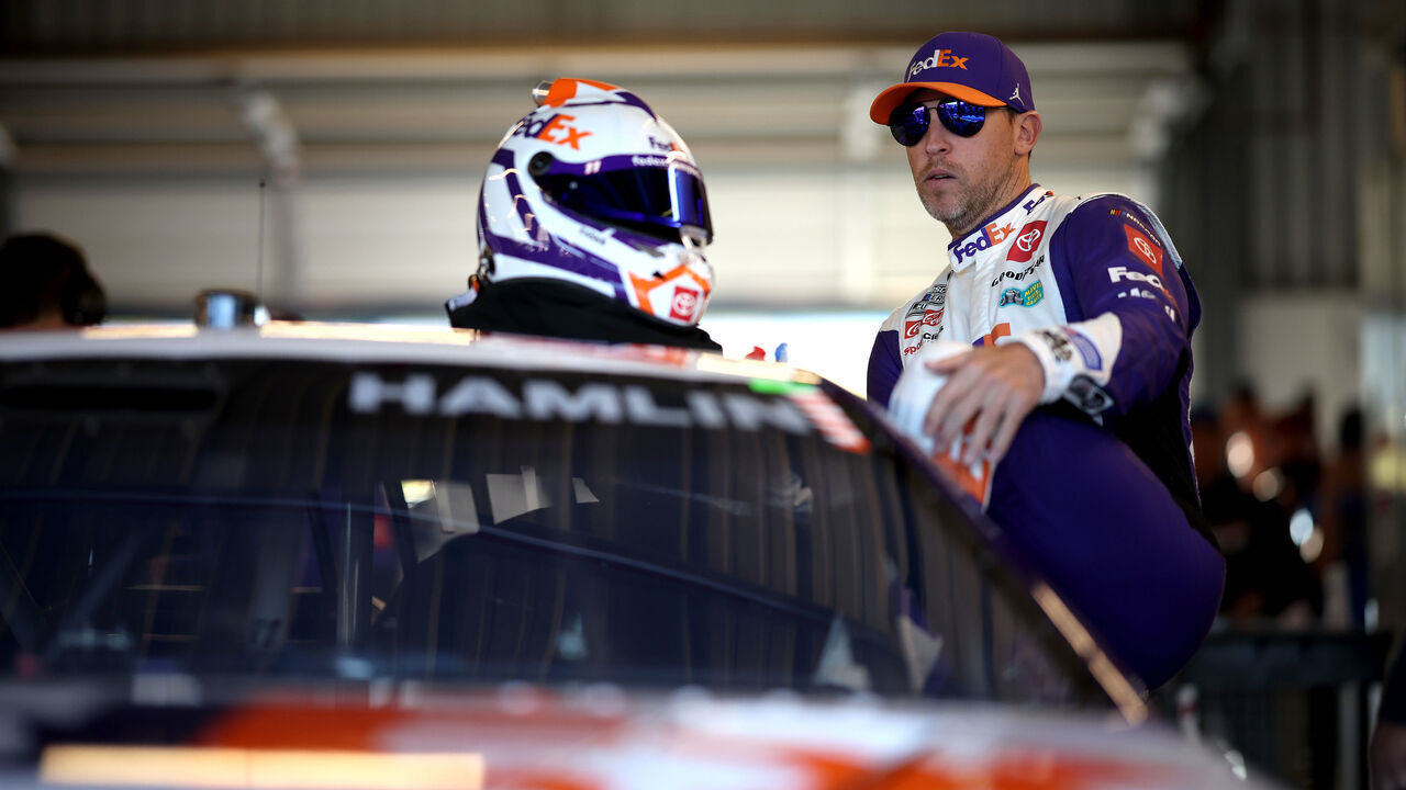 AVONDALE, ARIZONA - NOVEMBER 08: Denny Hamlin, driver of the #11 FedEx Toyota, enters his car in the garage area during practice for the NASCAR Cup Series Championship Race at Phoenix Raceway on November 08, 2024 in Avondale, Arizona.