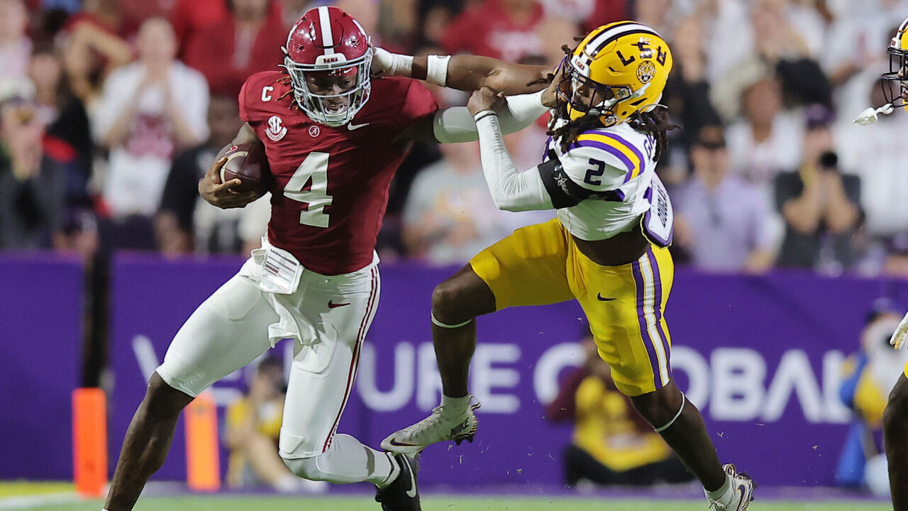 BATON ROUGE, LOUISIANA - NOVEMBER 09: Jalen Milroe #4 of the Alabama Crimson Tide runs with the ball as Jardin Gilbert #2 of the LSU Tigers defends during the first half at Tiger Stadium on November 09, 2024 in Baton Rouge, Louisiana.