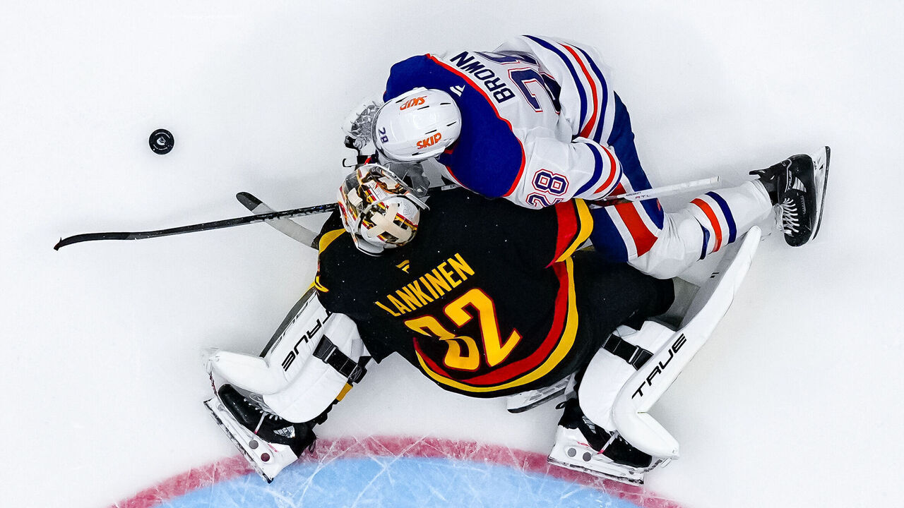VANCOUVER, CANADA - NOVEMBER 9: Connor Brown #28 of the Edmonton Oilers collides with Kevin Lankinen #32 of the Vancouver Canucks during the second period of their NHL game at Rogers Arena on November 9, 2024 in Vancouver, British Columbia, Canada.