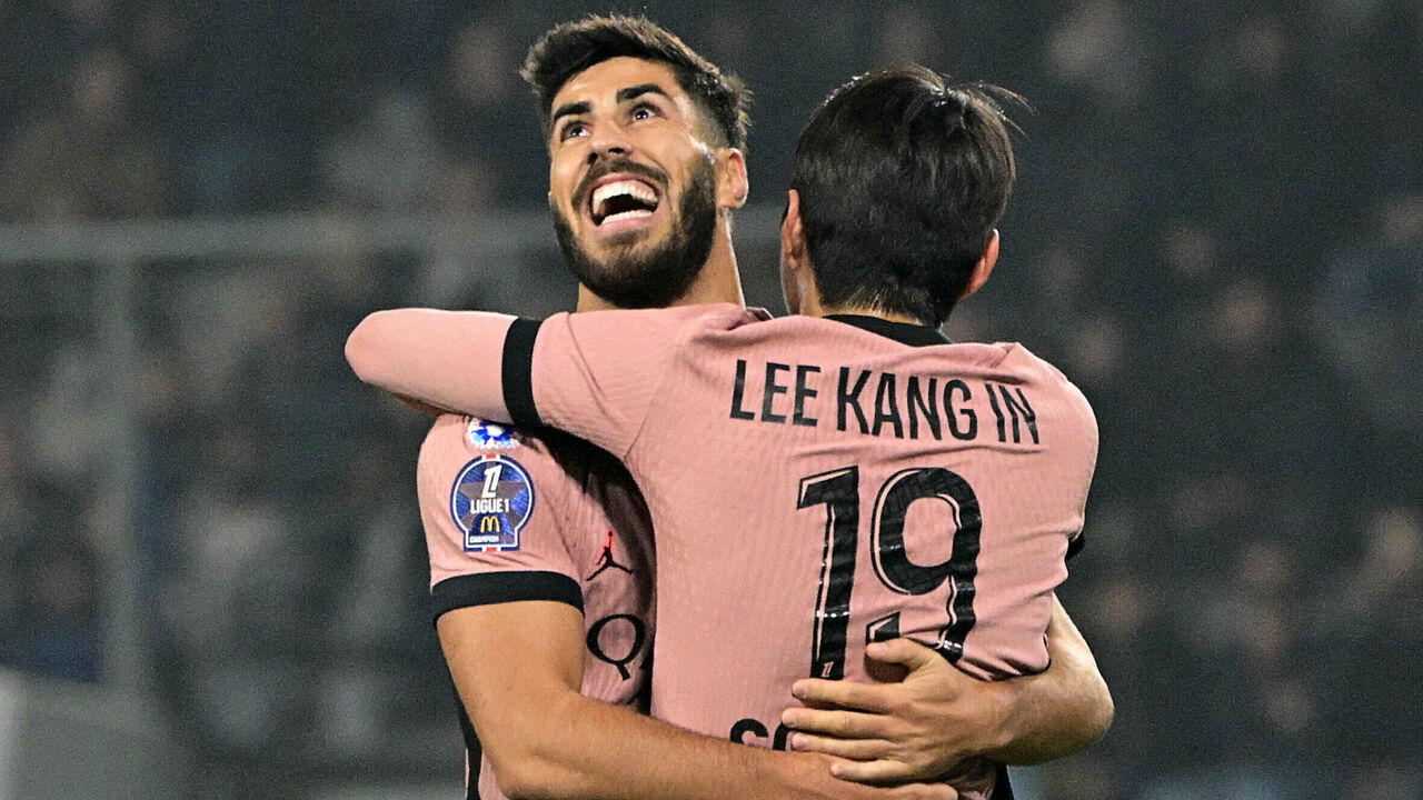 Paris Saint-Germain's South Korean midfielder #19 Lee Kang-in (BACK) celebrates with Paris Saint-Germain's Spanish forward #11 Marco Asensio after scoring his team's first goal during the French L1 football match between SCO Angers and Paris Saint-Germain (PSG) at The Raymond-Kopa Stadium in Angers, western France, on November 9, 2024.