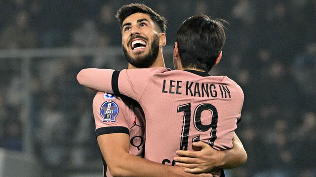 Paris Saint-Germain's South Korean midfielder #19 Lee Kang-in (BACK) celebrates with Paris Saint-Germain's Spanish forward #11 Marco Asensio after scoring his team's first goal during the French L1 football match between SCO Angers and Paris Saint-Germain (PSG) at The Raymond-Kopa Stadium in Angers, western France, on November 9, 2024.