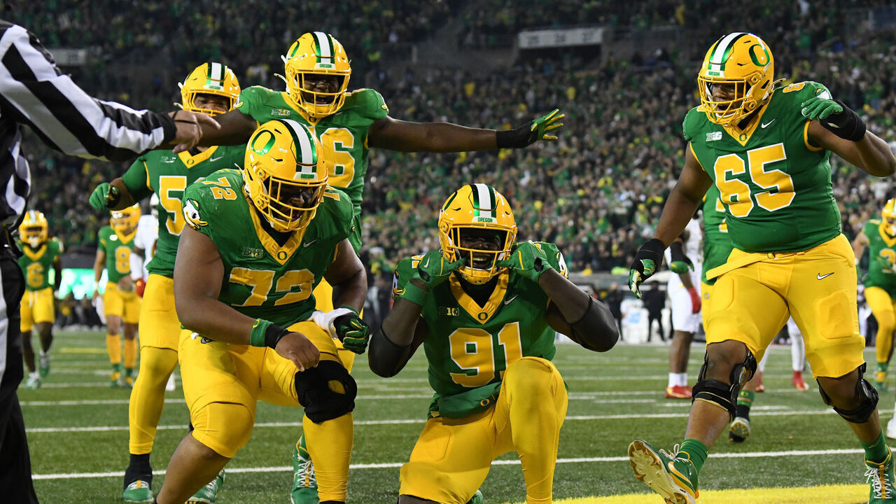 EUGENE, OR - NOVEMBER 09: Oregon Ducks offensive tackle Genorris Wilson (91) celebrates with Oregon Ducks offensive lineman Iapani Laloulu (72) and Oregon Ducks offensive lineman Ajani Cornelius (65) during a college football game between the Maryland Terrapins and Oregon Ducks on November 9, 2024, at Autzen Stadium in Eugene, Oregon.