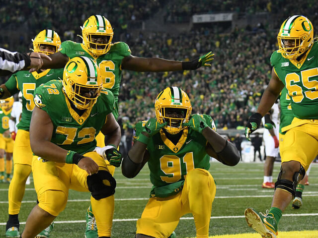 EUGENE, OR - NOVEMBER 09: Oregon Ducks offensive tackle Genorris Wilson (91) celebrates with Oregon Ducks offensive lineman Iapani Laloulu (72) and Oregon Ducks offensive lineman Ajani Cornelius (65) during a college football game between the Maryland Terrapins and Oregon Ducks on November 9, 2024, at Autzen Stadium in Eugene, Oregon.
