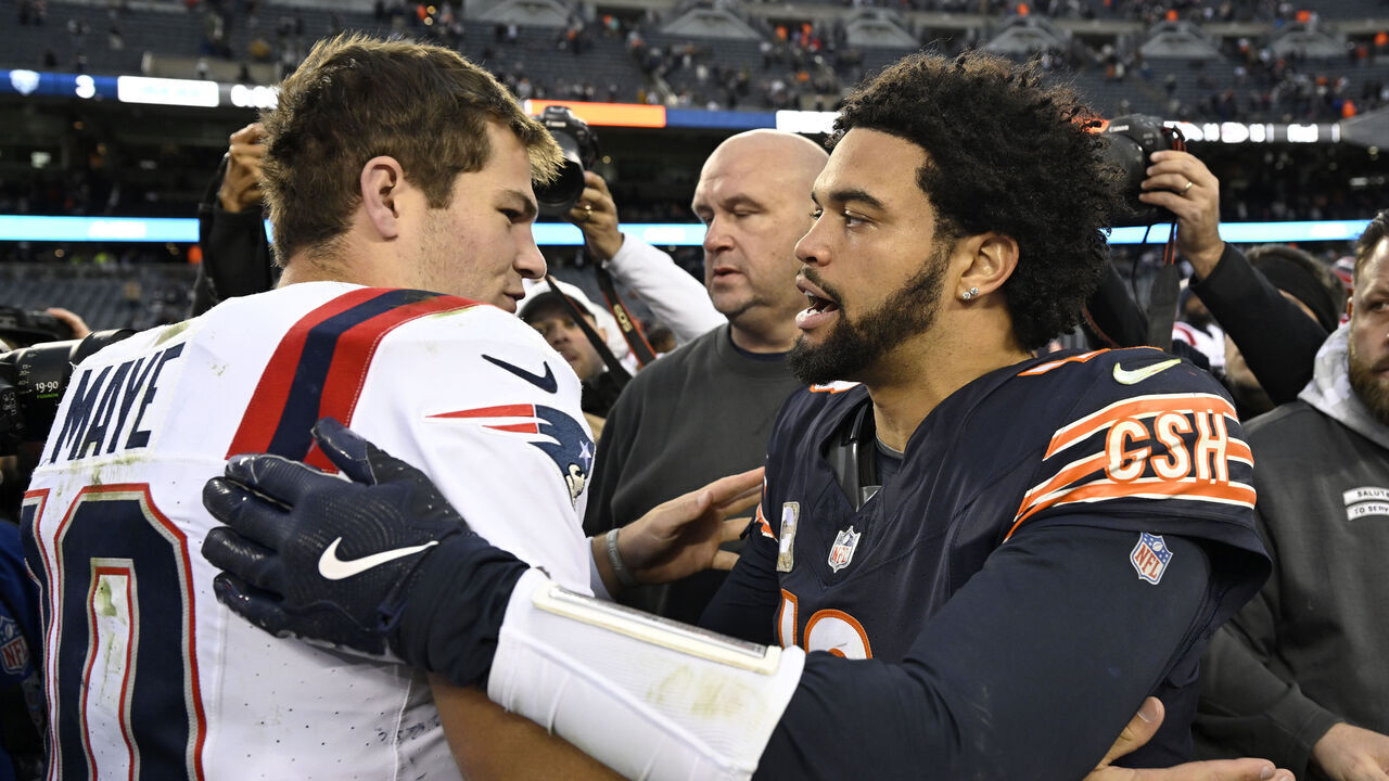 CHICAGO, ILLINOIS - NOVEMBER 10: Caleb Williams #18 of the Chicago Bears and Drake Maye #10 of the New England Patriots embrace after the game at Soldier Field on November 10, 2024 in Chicago, Illinois.