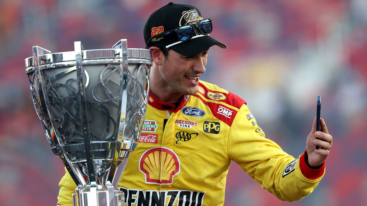 AVONDALE, ARIZONA - NOVEMBER 10: Joey Logano, driver of the #22 Shell Pennzoil Ford, takes a selfie with the Bill France NASCAR Cup Series Championship trophy in victory lane after winning the NASCAR Cup Series Championship Race at Phoenix Raceway on November 10, 2024 in Avondale, Arizona.