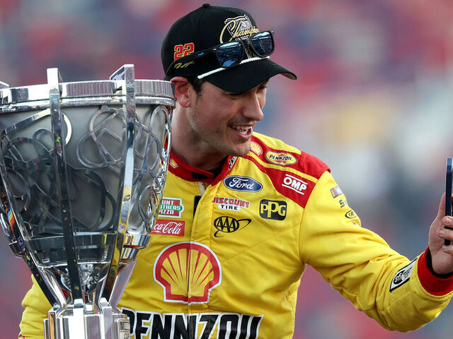 AVONDALE, ARIZONA - NOVEMBER 10: Joey Logano, driver of the #22 Shell Pennzoil Ford, takes a selfie with the Bill France NASCAR Cup Series Championship trophy in victory lane after winning the NASCAR Cup Series Championship Race at Phoenix Raceway on November 10, 2024 in Avondale, Arizona.