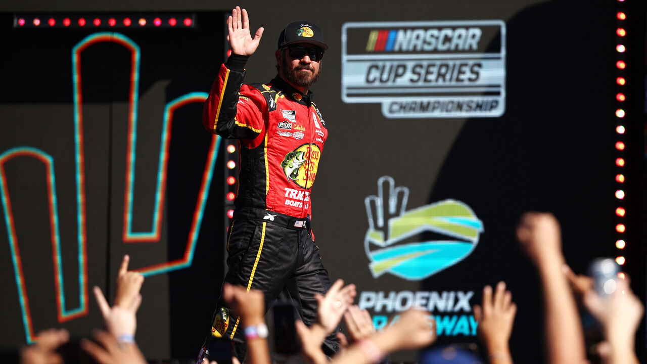 AVONDALE, ARIZONA - NOVEMBER 10: Retiring from full-time NASCAR competition Martin Truex Jr., driver of the #19 Bass Pro Shops Toyota, waves to fans as he walks onstage during driver intros prior to the NASCAR Cup Series Championship Race at Phoenix Raceway on November 10, 2024 in Avondale, Arizona.