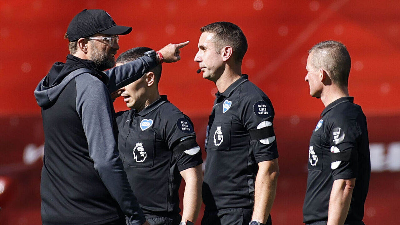 Liverpool's German manager Jurgen Klopp (L) speaks to referee referee David Coote (2R) after the English Premier League football match between Liverpool and Burnley at Anfield in Liverpool, north west England on July 11, 2020.