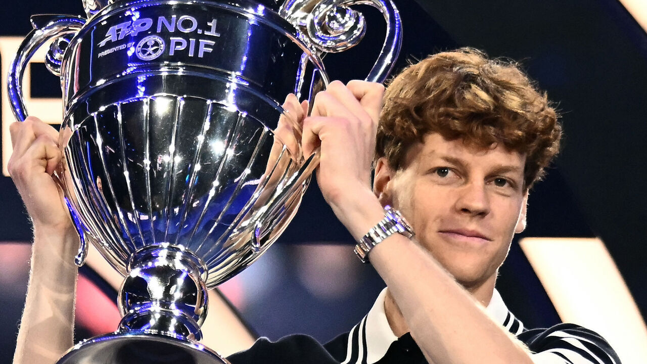 TOPSHOT - Italy's Jannik Sinner poses with the ATP year-end No.1 trophy during the ATP Finals tennis tournament in Turin on November 11, 2024.