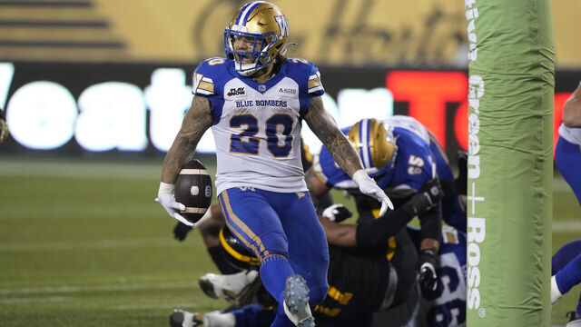 HAMILTON, CANADA - OCTOBER 4: Brady Oliveira #20 of the Winnipeg Blue Bombers reacts after scoring a rushing touchdown against the Hamilton Tiger-Cats at Tim Hortons Field on October 4, 2024 in Hamilton, Canada.