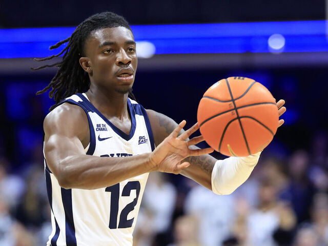 INDIANAPOLIS, INDIANA - NOVEMBER 11: Kolby King #12 of the Butler Bulldogs passes the ball during the first half against the Western Michigan Broncos at Hinkle Fieldhouse on November 11, 2024 in Indianapolis, Indiana.