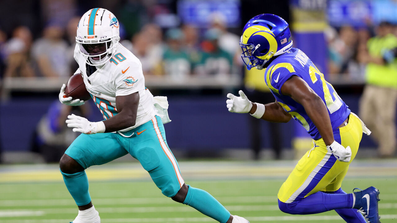 INGLEWOOD, CALIFORNIA - NOVEMBER 11: Tyreek Hill #10 of the Miami Dolphins runs the ball against Kamren Kinchens #26 of the Los Angeles Rams during the second quarter in the game at SoFi Stadium on November 11, 2024 in Inglewood, California.