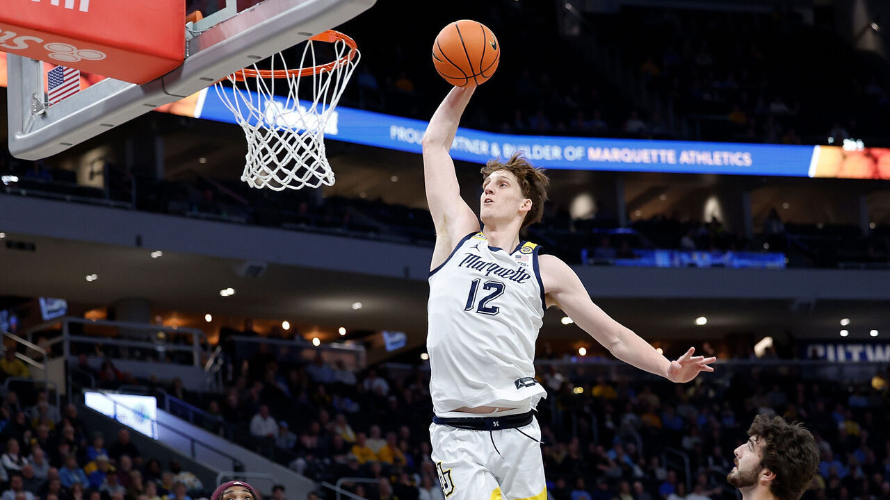 MILWAUKEE, WISCONSIN - NOVEMBER 11: Ben Gold #12 of the Marquette Golden Eagles scores on a slam dunk in the first half of the game against the Central Michigan Chippewas at Fiserv Forum on November 11, 2024 in Milwaukee, Wisconsin.
