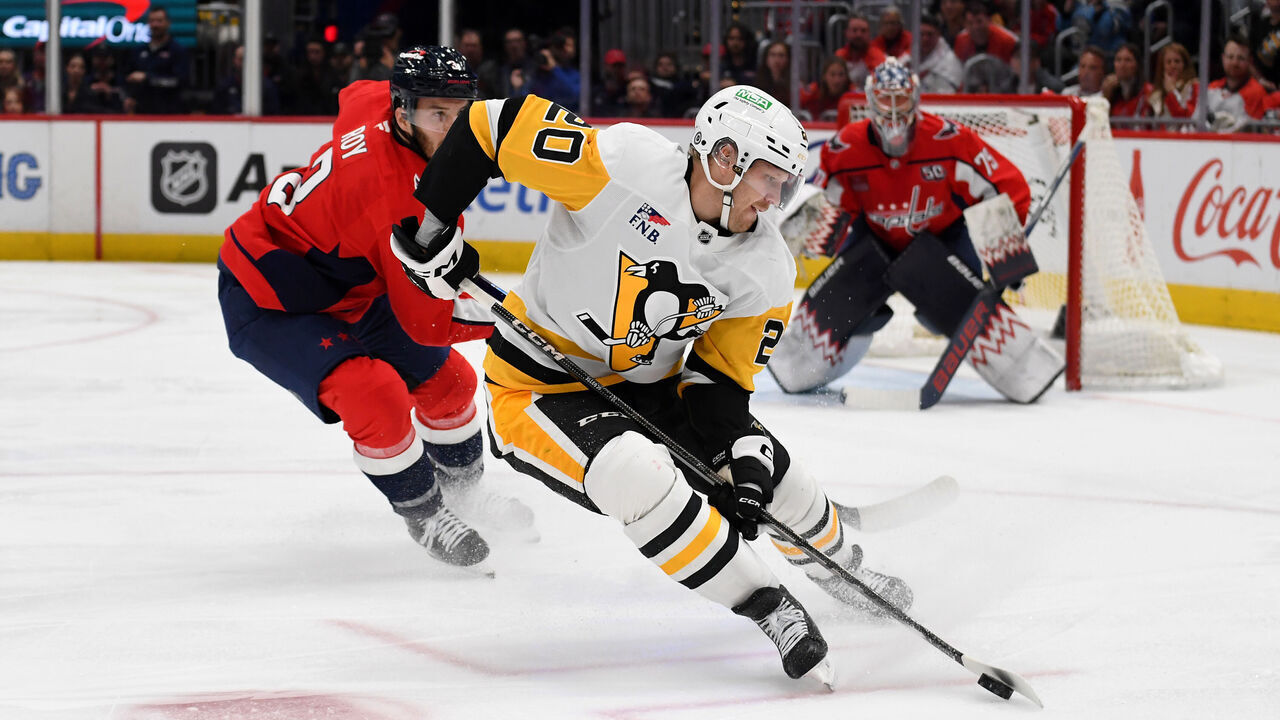 WASHINGTON, DC - NOVEMBER 08: Penguins center Lars Eller (20) cuts with the puck in front of Capitals defenseman Matt Roy (3) and goalie Charlie Lindgren (79) during the Pittsburgh Penguins versus Washington Capitals National Hockey League game on November 8, 2024 at Capital One Arena in Washington, D.C..