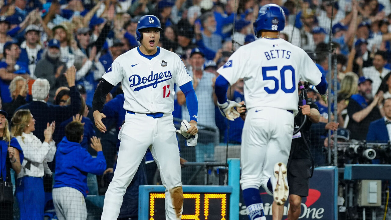 LOS ANGELES, CA - OCTOBER 25: Shohei Ohtani #17 and Mookie Betts #50 of the Los Angeles Dodgers celebrate after Ohtani scored in the eighth inning of Game 1 of the 2024 World Series presented by Capital One between the New York Yankees and the Los Angeles Dodgers at Dodger Stadium on Friday, October 25, 2024 in Los Angeles, California.