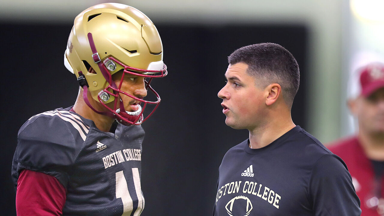Boston, MA - September 24: Boston College quarterbacks coach Jonathan DiBiaso talks with QB Grayson James at practice.