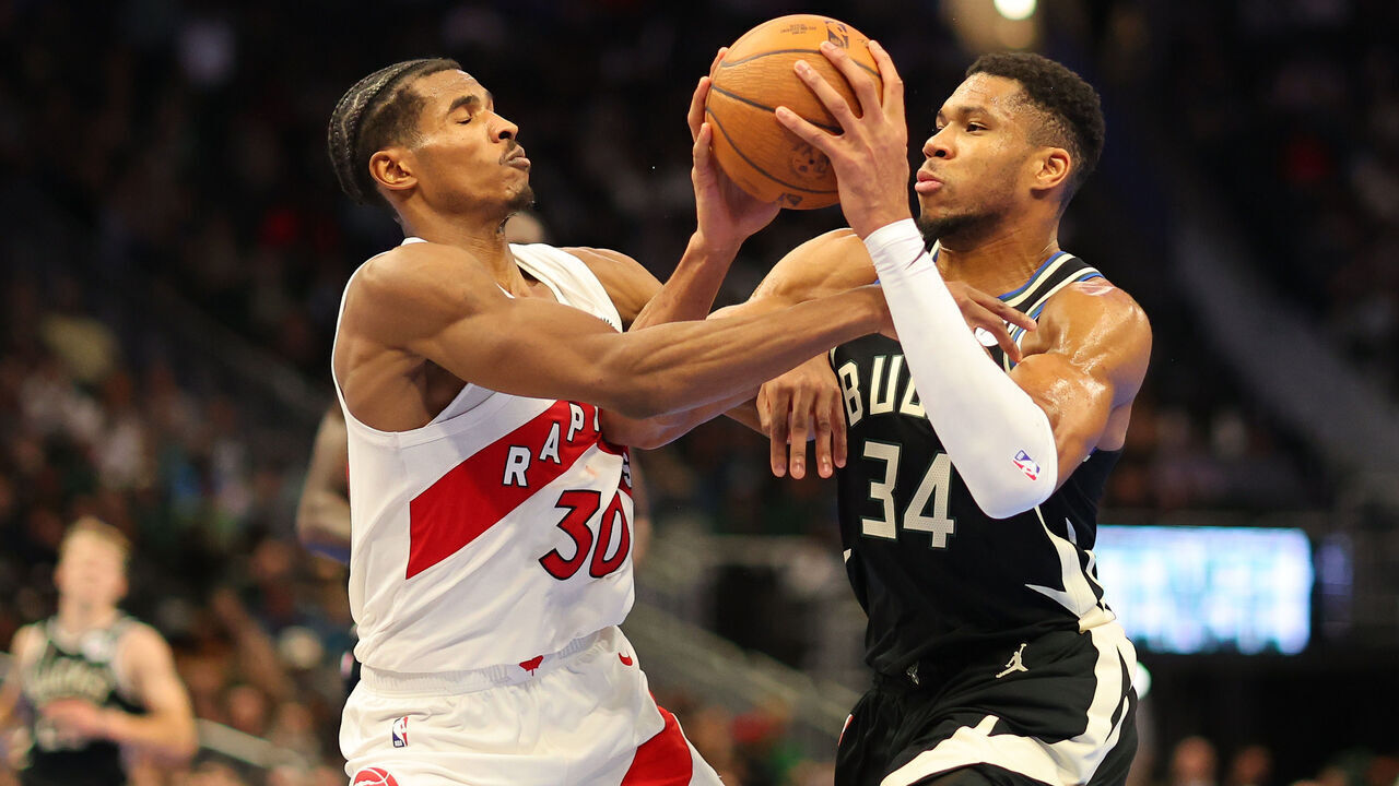 MILWAUKEE, WISCONSIN - NOVEMBER 12: Giannis Antetokounmpo #34 of the Milwaukee Bucks is fouled by Ochai Agbaji #30 of the Toronto Raptors during the second half of a game in the NBA Emirates Cup at Fiserv Forum on November 12, 2024 in Milwaukee, Wisconsin.