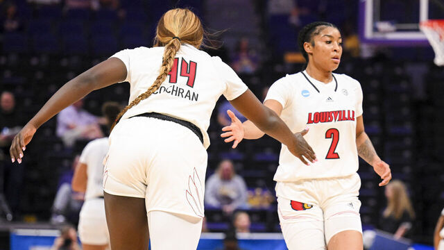 BATON ROUGE, LOUISIANA - MARCH 22: Olivia Cochran of the Louisville Cardinals high fives teammate Nyla Harris of the Louisville Cardinals during the first round of the 2024 NCAA Women's Basketball Tournament held at Pete Maravich Assembly Center on March 22, 2024 in Baton Rouge, Louisiana.