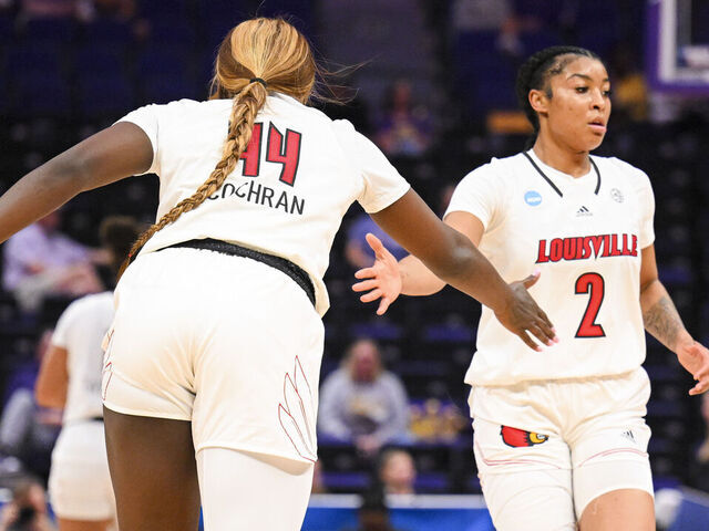 BATON ROUGE, LOUISIANA - MARCH 22: Olivia Cochran of the Louisville Cardinals high fives teammate Nyla Harris of the Louisville Cardinals during the first round of the 2024 NCAA Women's Basketball Tournament held at Pete Maravich Assembly Center on March 22, 2024 in Baton Rouge, Louisiana.