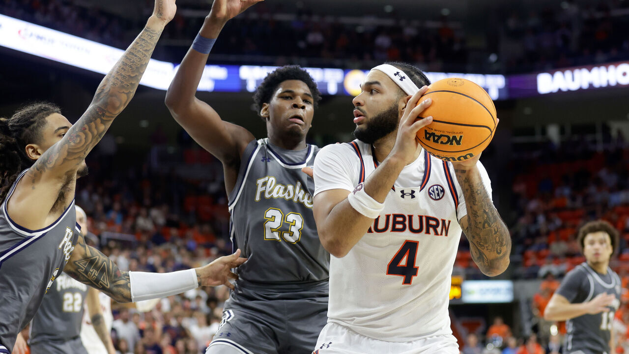 AUBURN, ALABAMA - NOVEMBER 13: Johni Broome #4 of the Auburn Tigers is defended by Delrecco Gillespie #23 of the Kent State Golden Flashes during the second half at Neville Arena on November 13, 2024 in Auburn, Alabama.