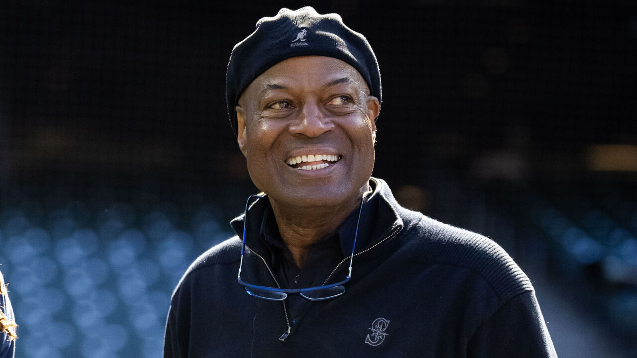 SEATTLE, WASHINGTON - MAY 31: J.P. Crawford #3 and broadcaster Dave Sims of the Seattle Mariners share a laugh during bats practice at T-Mobile Park on May 31, 2024 in Seattle, Washington.