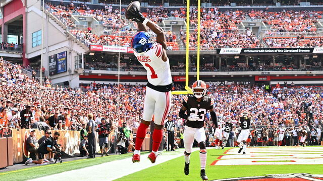 CLEVELAND, OHIO - SEPTEMBER 22: Malik Nabers #1 of the New York Giants catches a touchdown pass in front of Martin Emerson Jr. #23 of the Cleveland Browns during the second quarter at Cleveland Browns Stadium on September 22, 2024 in Cleveland, Ohio.