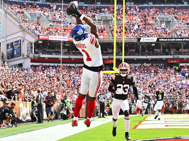CLEVELAND, OHIO - SEPTEMBER 22: Malik Nabers #1 of the New York Giants catches a touchdown pass in front of Martin Emerson Jr. #23 of the Cleveland Browns during the second quarter at Cleveland Browns Stadium on September 22, 2024 in Cleveland, Ohio.