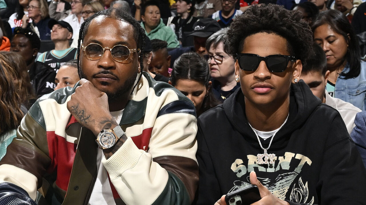 BROOKLYN, NY - OCTOBER 1: Carmelo Anthony and Kiyan Anthony sit court side during the game between the Las Vegas Aces and the New York Liberty during Round Two Game Two of the 2024 WNBA Playoffs on October 1, 2024 in Brooklyn, New York. Mandatory Copyright Notice: Copyright 2024 NBAE