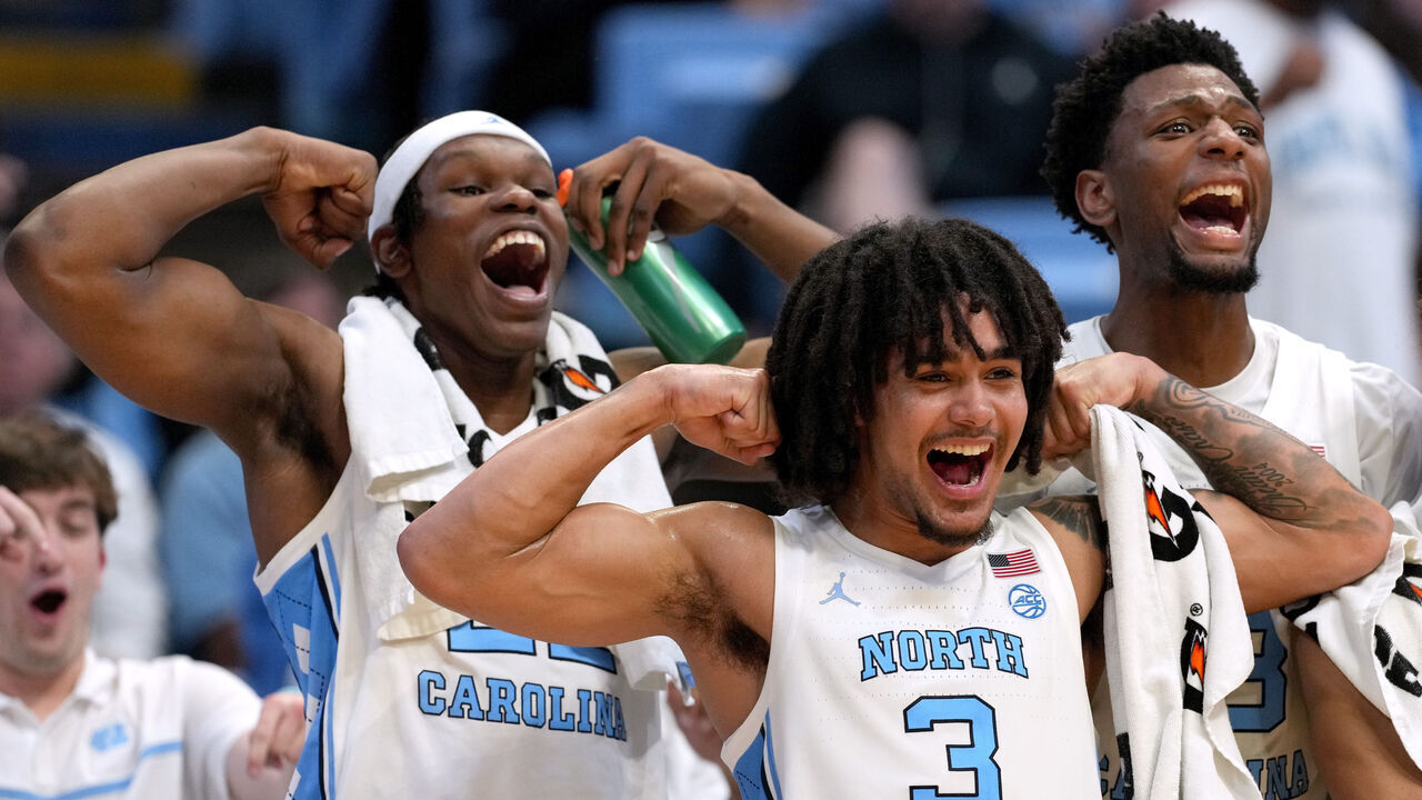 CHAPEL HILL, NORTH CAROLINA - NOVEMBER 15: (L-R) Ven-Allen Lubin #22, Elliot Cadeau #3 and Jalen Washington #13 of the North Carolina Tar Heels react to a basket by the reserves during the second half of the game against the American University Eagles at the Dean E. Smith Center on November 15, 2024 in Chapel Hill, North Carolina.