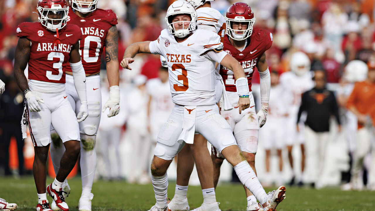 FAYETTEVILLE, ARKANSAS - NOVEMBER 16: Quinn Ewers #3 of the Texas Longhorns celebrates after getting a first down in the second half during a game against the Arkansas Razorbacks at Donald W. Reynolds Razorback Stadium on November 16, 2024 in Fayetteville, Arkansas. The Longhorns defeated the Razorbacks 20-10.