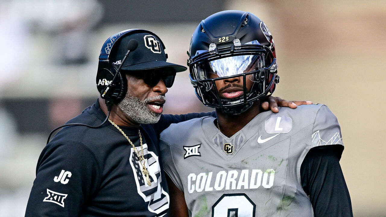 BOULDER, CO - NOVEMBER 16: Head coach Deion Sanders of the Colorado Buffaloes celebrates with Shedeur Sanders #2 after a fourth quarter touchdown against the Utah Utes at Folsom Field on November 16, 2024 in Boulder, Colorado.
