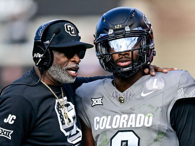 BOULDER, CO - NOVEMBER 16: Head coach Deion Sanders of the Colorado Buffaloes celebrates with Shedeur Sanders #2 after a fourth quarter touchdown against the Utah Utes at Folsom Field on November 16, 2024 in Boulder, Colorado.